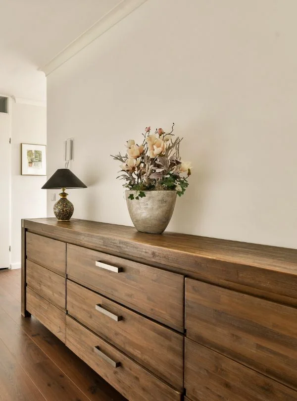 Aparador de madera oscura con cajones amplios y acabado artesanal
